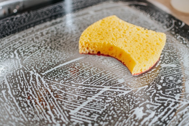 Yellow sponge on a soapy surface